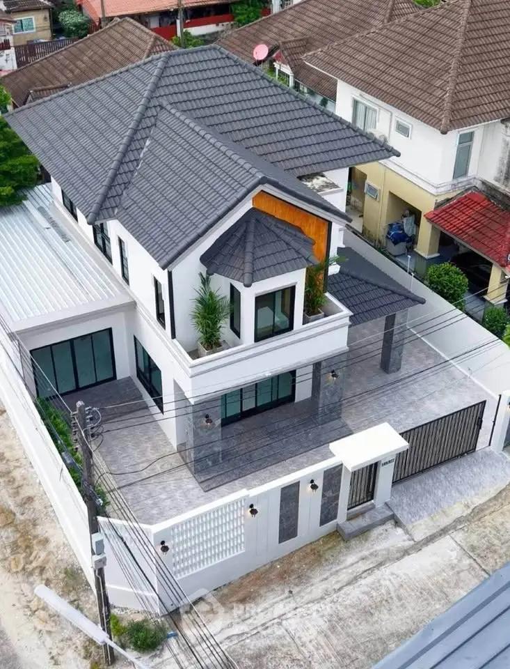 Stunning modern two-story house with sleek design and spacious outdoor area.