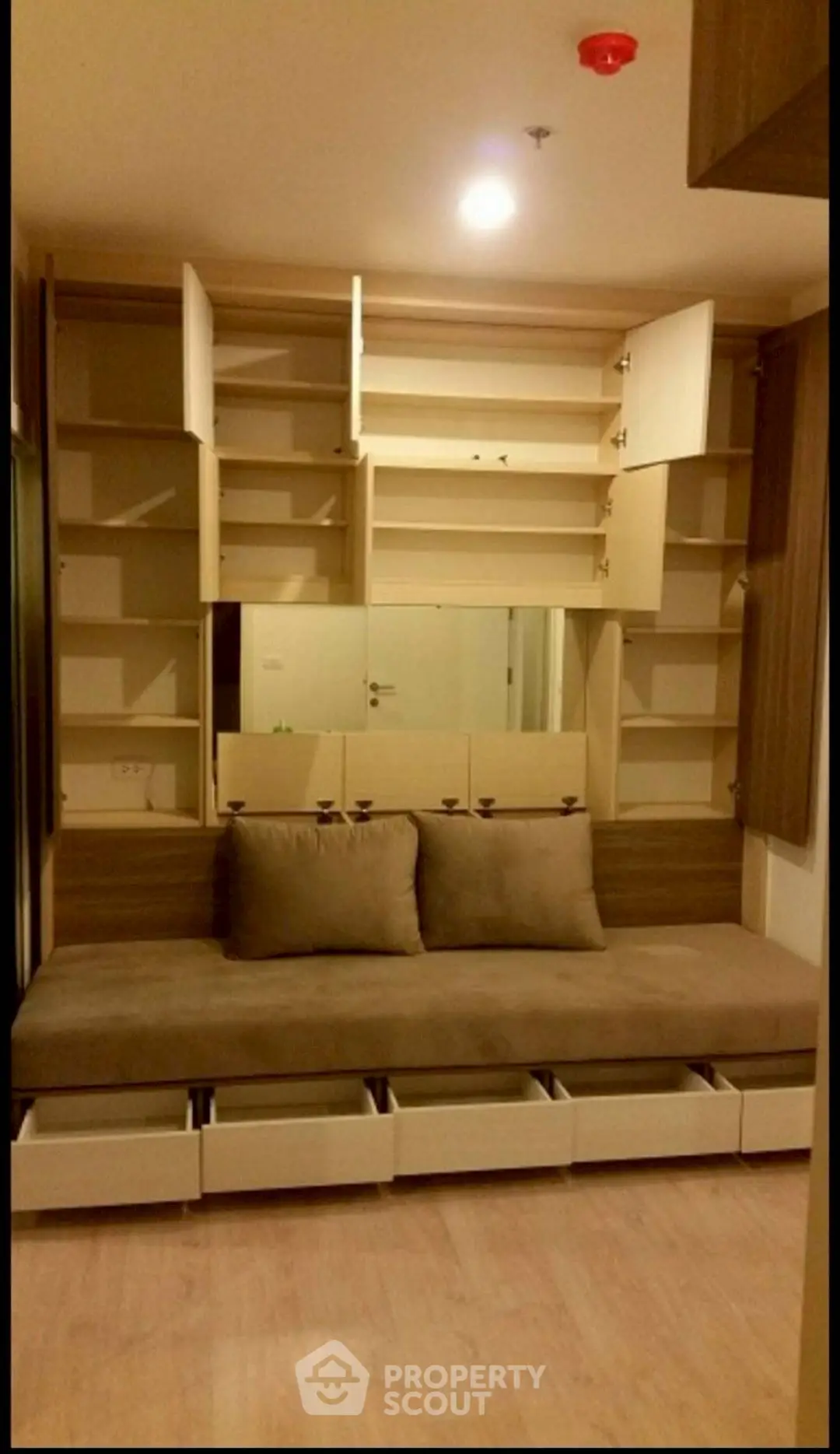 Modern living room with built-in storage and cozy seating area.