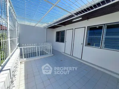 Spacious tiled balcony with white railing and modern design, perfect for outdoor relaxation.