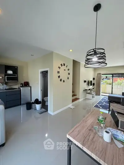 Modern open-plan living area with sleek kitchen and stylish decor, perfect for contemporary living.