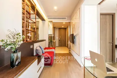 Modern living room with stylish decor and open layout, featuring wooden flooring and elegant furniture.