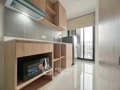 Modern kitchen with sleek cabinetry and balcony view