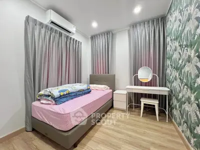 Cozy bedroom with single bed, stylish wallpaper, and vanity desk, perfect for a serene retreat.