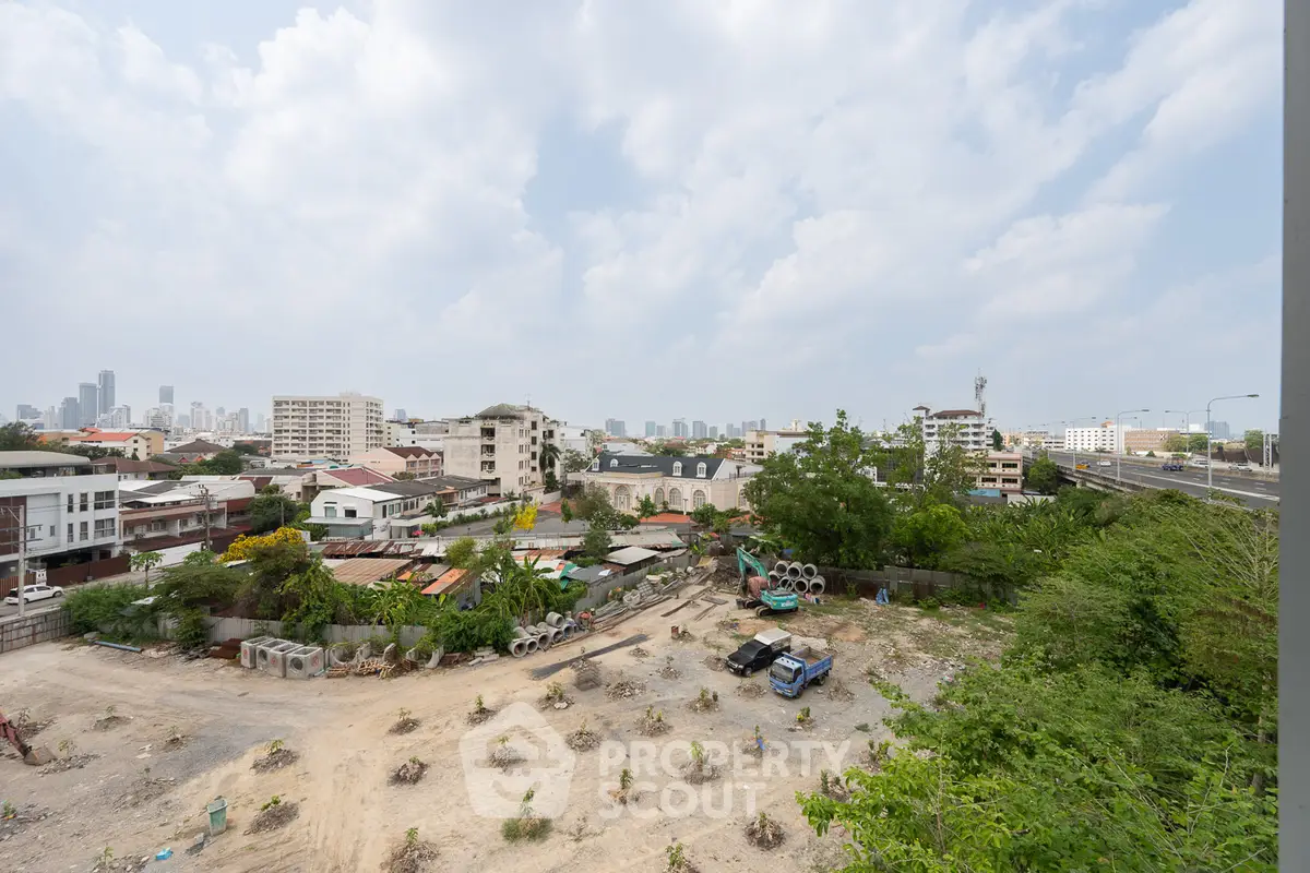 Expansive urban view showcasing potential real estate development site with city skyline backdrop.
