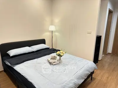 Cozy bedroom with modern decor and soft lighting, perfect for relaxation.