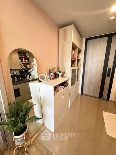 Stylish modern entryway with sleek storage and decorative mirror