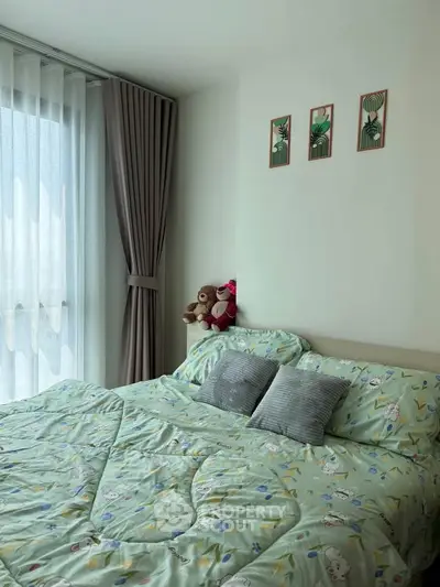 Cozy bedroom with large window and stylish decor, perfect for relaxation.