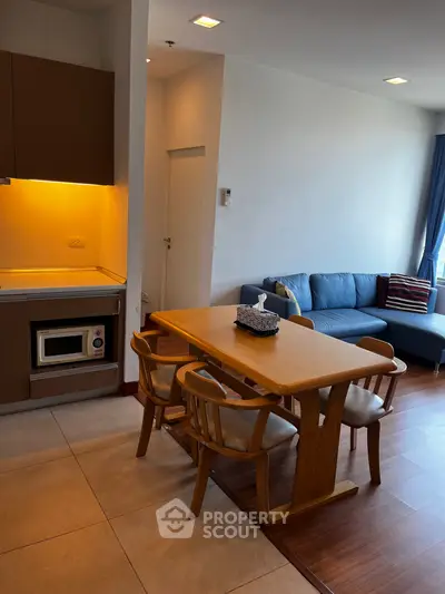 Modern open-layout kitchen and living room with cozy seating and dining area.