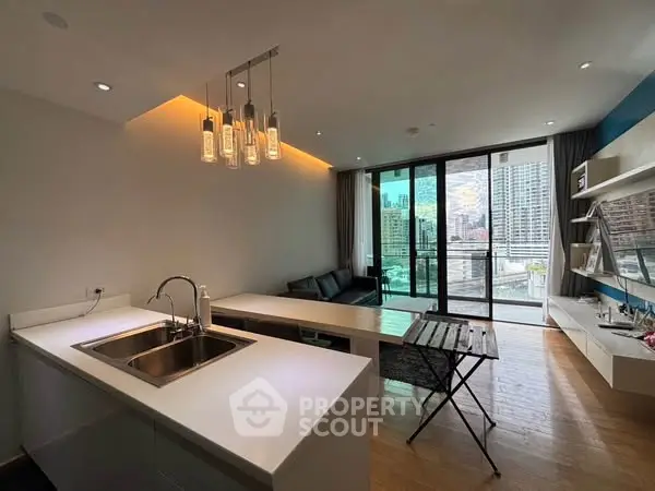 Modern open-layout living room with city view and stylish kitchen island.