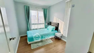 Bright and cozy bedroom with modern decor and large window for natural light.