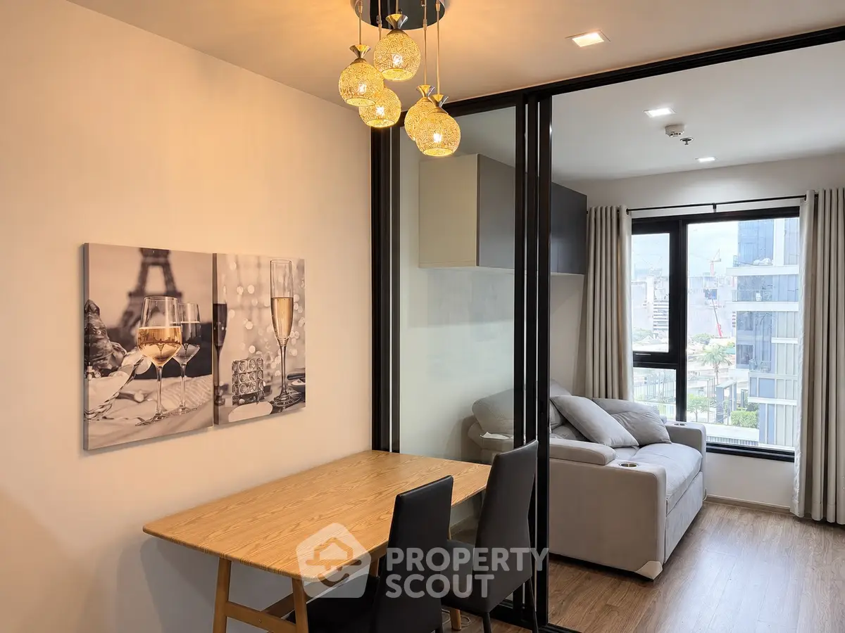 Modern apartment interior with stylish dining area and cozy living room featuring city view.