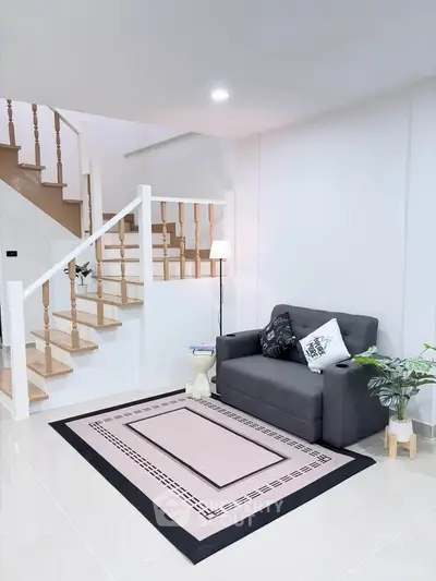 Modern living room with stylish staircase and cozy seating area