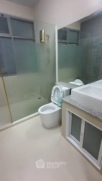 Modern bathroom with glass shower and sleek fixtures