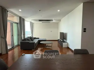 Spacious modern living room with large windows and stylish furniture