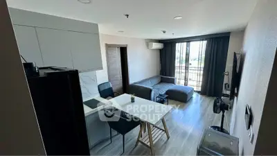 Modern living room with sleek furniture and balcony view in a stylish apartment.