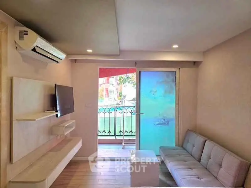 Modern living room with balcony access and sleek furniture design.