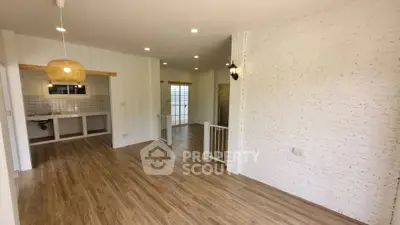 Spacious open-plan living area with modern wood flooring and stylish lighting