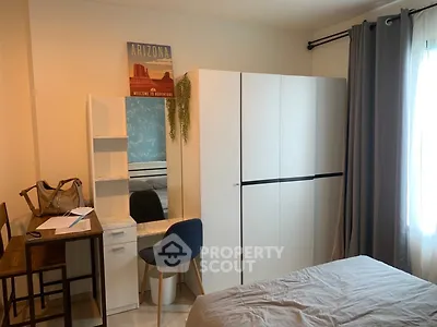 Cozy bedroom with modern furniture and natural light, perfect for relaxation and comfort.
