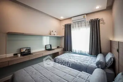 Modern twin bedroom with sleek design and ample natural light