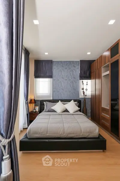 Elegant bedroom with modern decor and ample natural light
