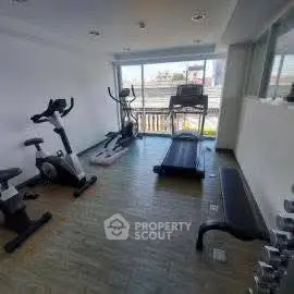 Modern gym with exercise equipment and large window view