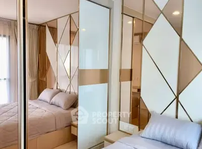 Modern bedroom with stylish mirrored closet and elegant decor