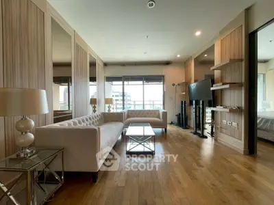Spacious modern living room with elegant decor and large windows offering city views.