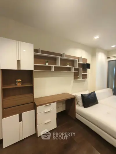 Modern living room with sleek shelving and comfortable white sofa