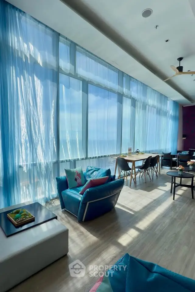 Luxurious living room with floor-to-ceiling windows and stunning ocean view