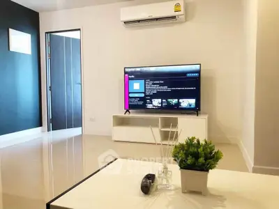 Modern living room with sleek TV setup and air conditioning