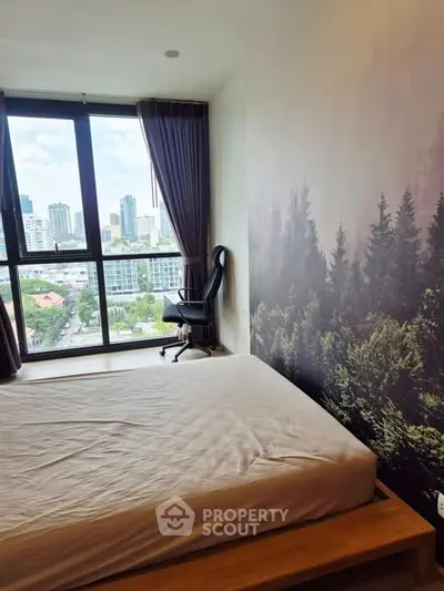 Modern bedroom with large window offering stunning city view and nature-themed wall decor.