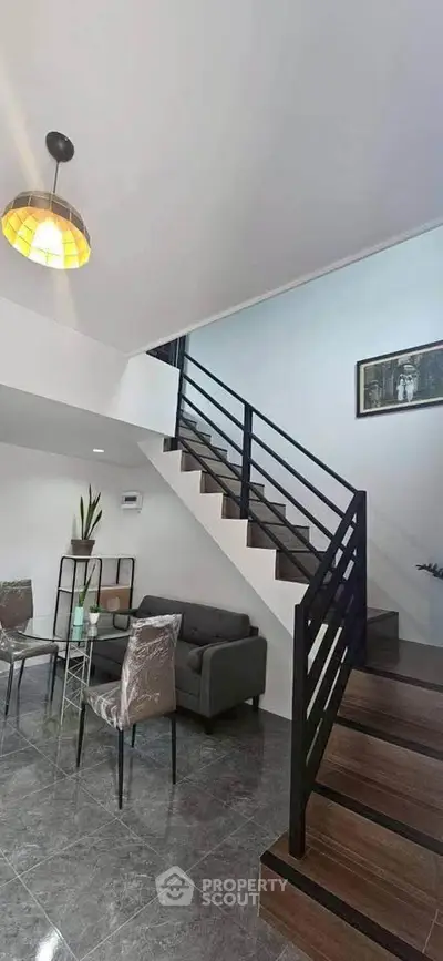 Modern duplex interior with stylish staircase and cozy living area