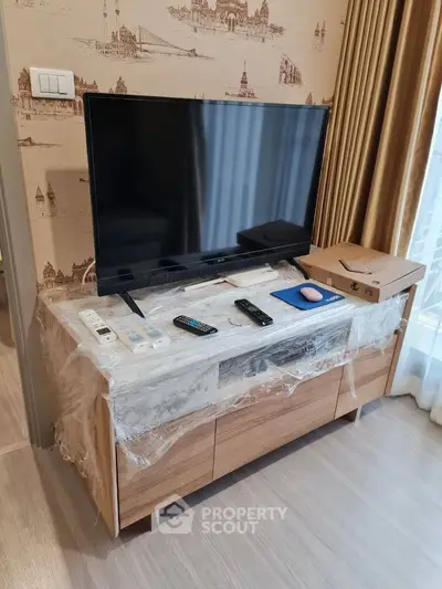 Modern living room with TV on wooden stand and stylish wallpaper