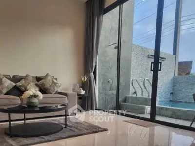 Modern living room with pool view and elegant decor