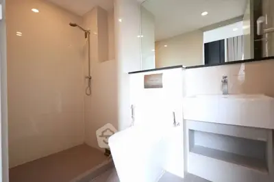 Modern bathroom with sleek shower and contemporary fixtures in a stylish apartment.