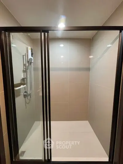 Modern bathroom with sleek glass shower enclosure and elegant tile design.