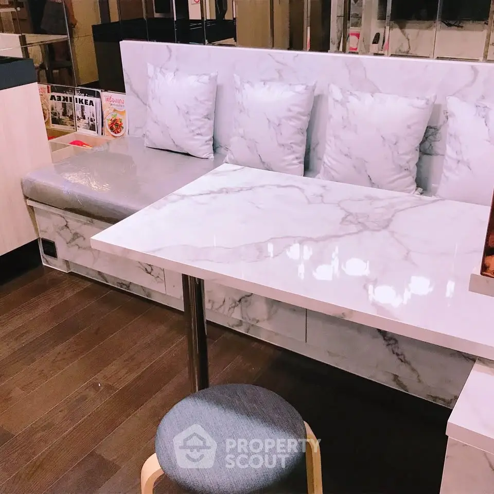 Stylish modern dining nook with marble table and cushioned seating