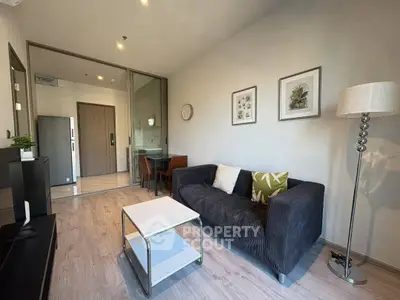 Modern living room with stylish decor and cozy seating in a contemporary apartment.