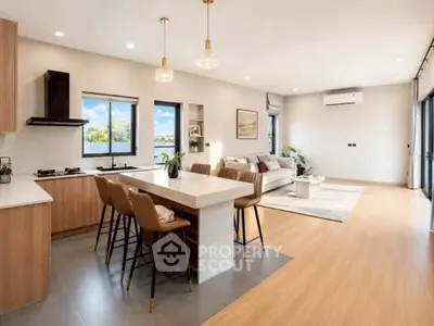 Spacious open-plan kitchen and living room with modern decor and natural light.