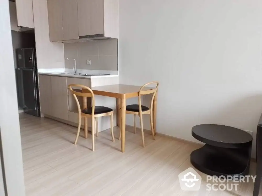 Modern kitchen with wooden dining set and sleek cabinetry