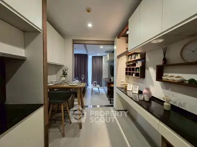 Modern open-plan kitchen and dining area with stylish decor and ample storage.