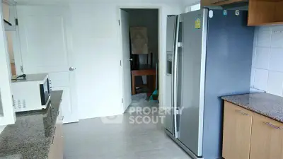 Spacious kitchen with modern appliances and sleek countertops in a contemporary home.