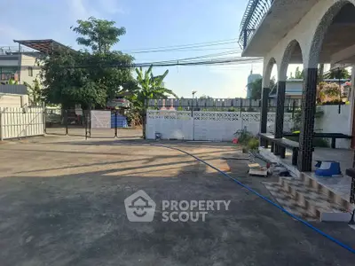 Spacious residential property with large driveway and modern exterior design.