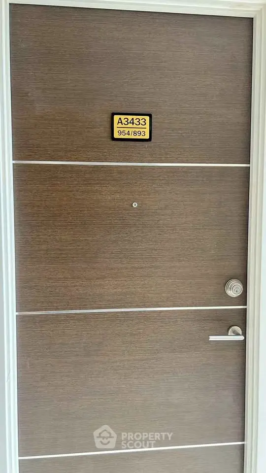 Modern apartment door with sleek design and room number plaque, ideal for urban living.