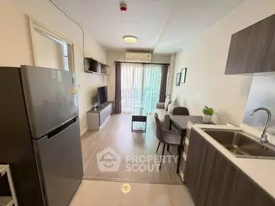 Modern living room with open kitchen and balcony view