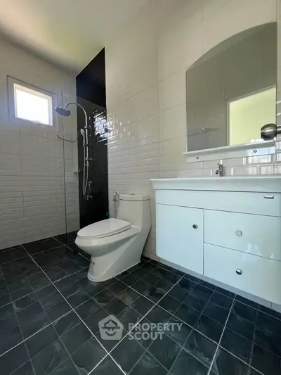 Modern bathroom with sleek black tiles and contemporary fixtures