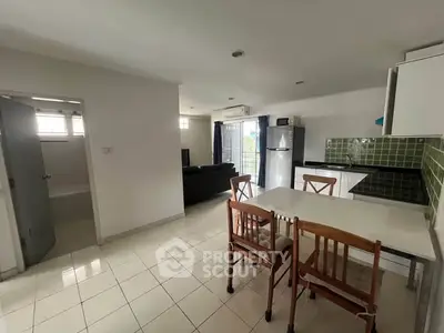 Spacious open-layout kitchen and dining area with modern appliances and natural light.