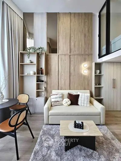 Modern living room with stylish decor and high ceilings in a contemporary apartment.