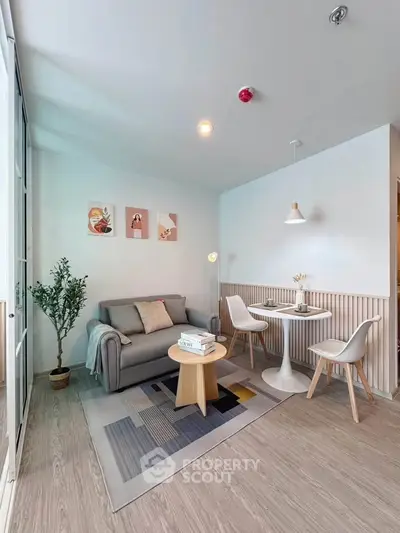 Modern living room with cozy seating and stylish decor in a bright apartment.