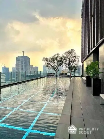 Luxurious rooftop infinity pool with panoramic city skyline view, perfect for upscale urban living and relaxation.